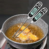 A digital food thermometer with an 88.5°C reading is inserted into a pan of cooking oil.