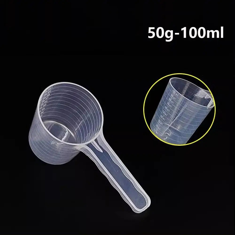 Clear plastic measuring cup with a long spout shown against a black background.