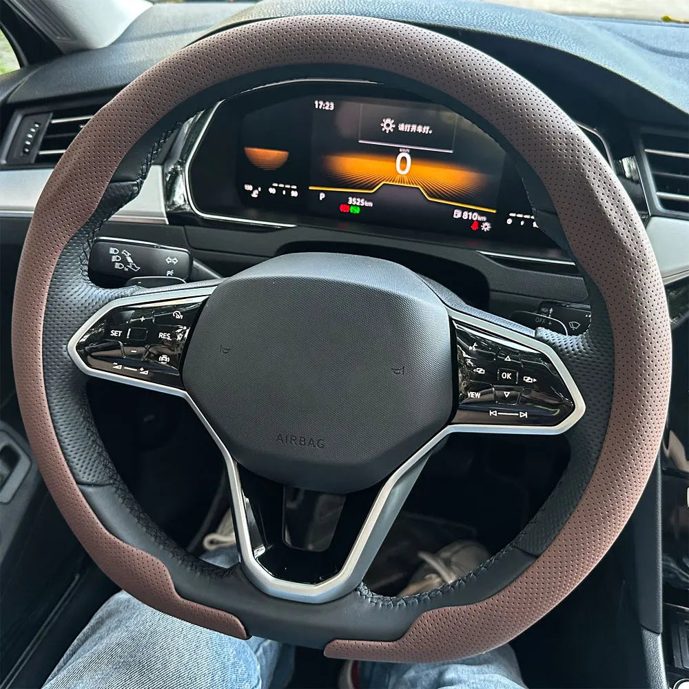 A close-up view of a brown leather steering wheel cover on a car's steering wheel.