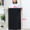A woman demonstrates the size of an extra large heavy-duty canvas laundry bag, showing its dimensions are 48cm wide and 80cm 