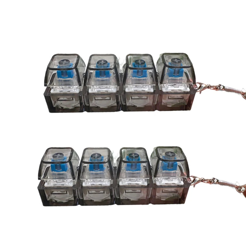 A set of ten clear plastic LED light-up keyboard keychains arranged in a row.