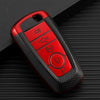 A red TPU leather car key cover with multiple buttons is shown on a black surface.