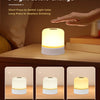 A white rechargeable night light is shown with three different light colors, demonstrating short press for switching and long