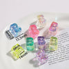 A collection of colorful acrylic alphabet beads in various shades and shapes displayed on a white plate.