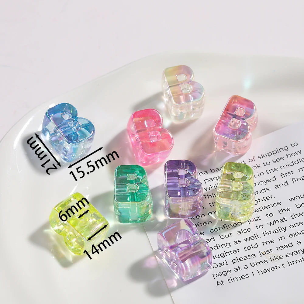 A collection of colorful acrylic alphabet beads in various shades and shapes displayed on a white plate.