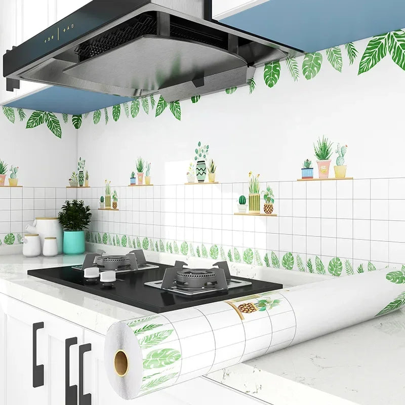 A roll of self-adhesive kitchen splashback sticker featuring green leaves and white tiles.