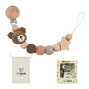 A wooden pacifier clip with a chain of crochet beads and a small tag for baby teething