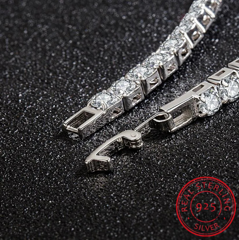 A close-up shot of an elegant 925 sterling silver tennis bracelet with cubic zirconia stones on a black textured surface.