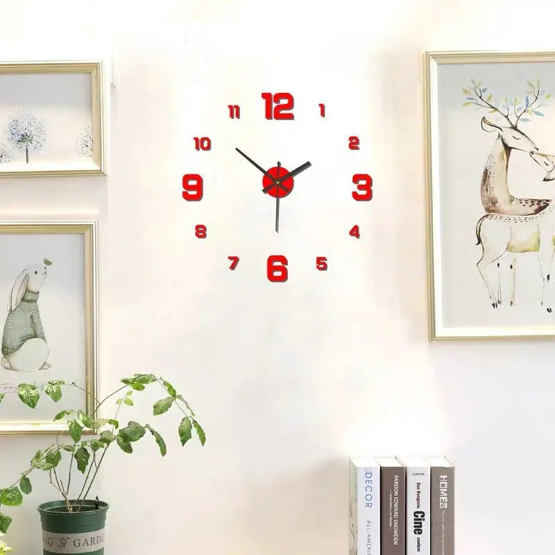 A round red and black analog wall clock with decorative framed artwork on a white wall.