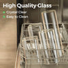 Clear glass storage canisters with bamboo lids stored in a metal rack.