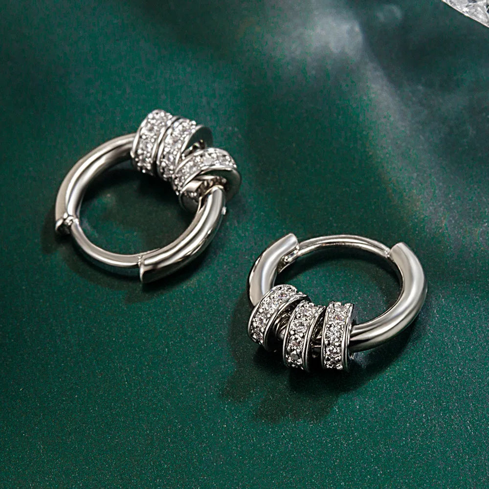 A pair of 925 sterling silver turquoise hoop earrings with intricate diamond detailing.