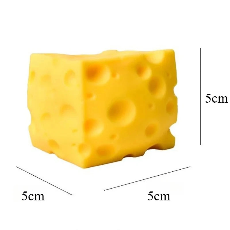 A yellow, cheese-shaped squishy stress relief toy with visible dimples.