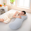 Una mujer apoya la cabeza en una almohada lateral de onda ergonómica azul claro sobre una cama blanca.
