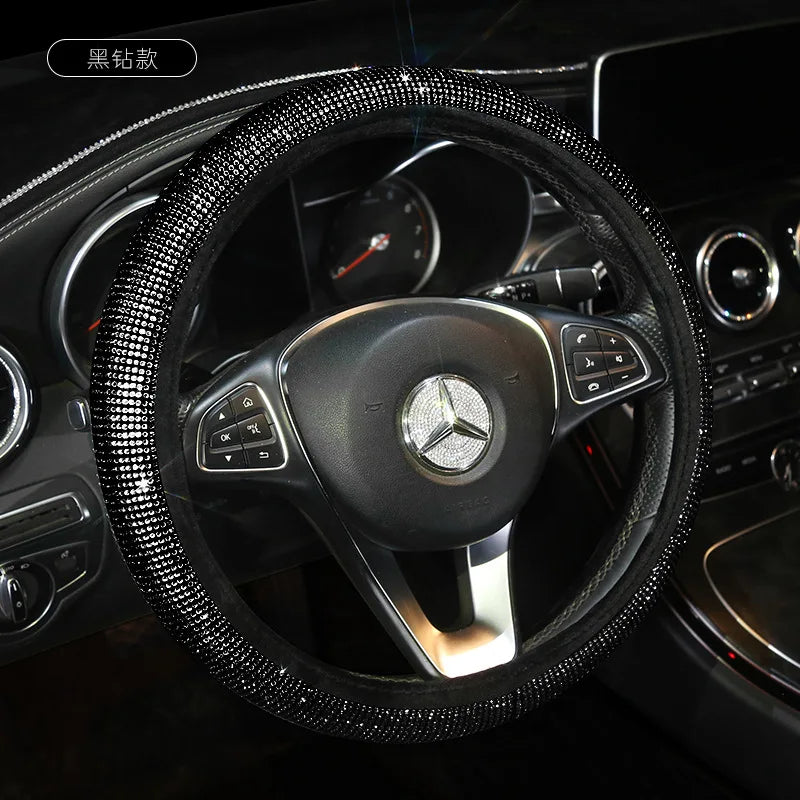 A black rhinestone steering wheel cover for a Mercedes vehicle interior.