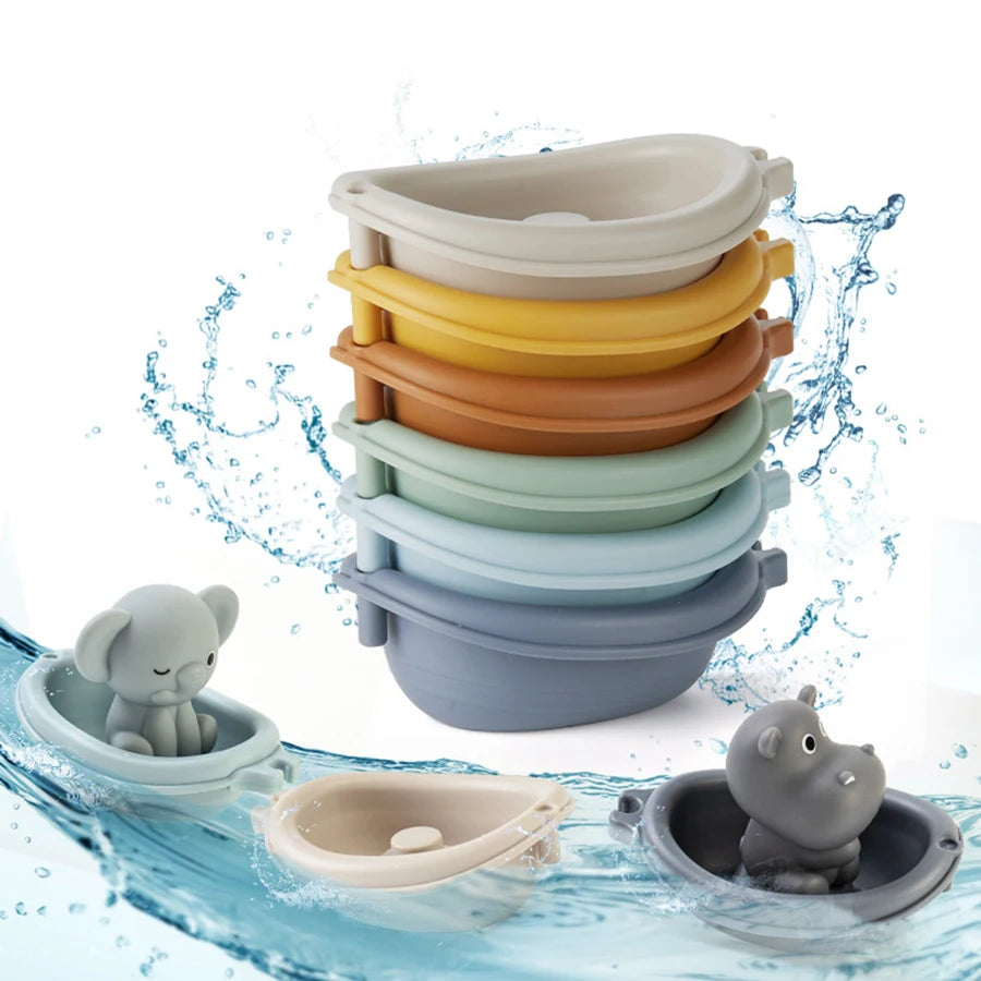 A stack of silicone animal finger puppet bath toys in various colors floating in water.