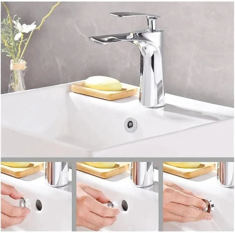 A chrome-plated sink overflow cover set is shown with a faucet and soap dishes on a white kitchen sink.