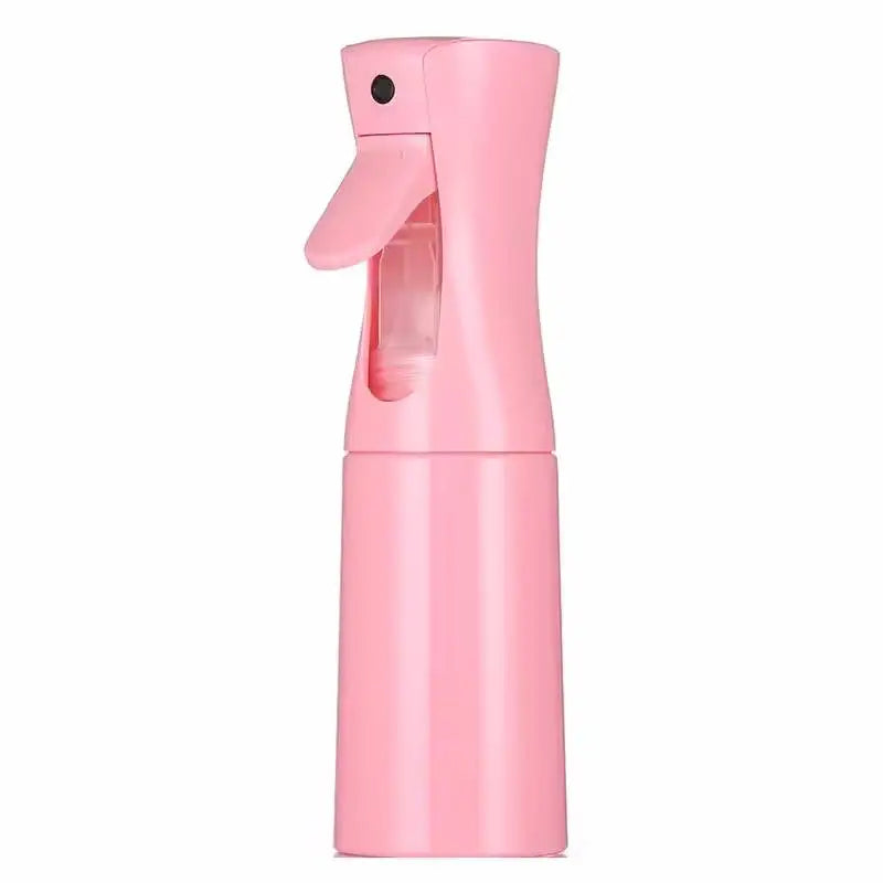 A pink refillable mist spray bottle with a nozzle, designed for hair, skin, and home use.