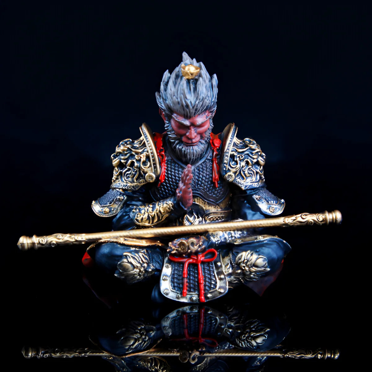 A hand-painted figurine of the Monkey King with a staff, featuring intricate armor and facial details.