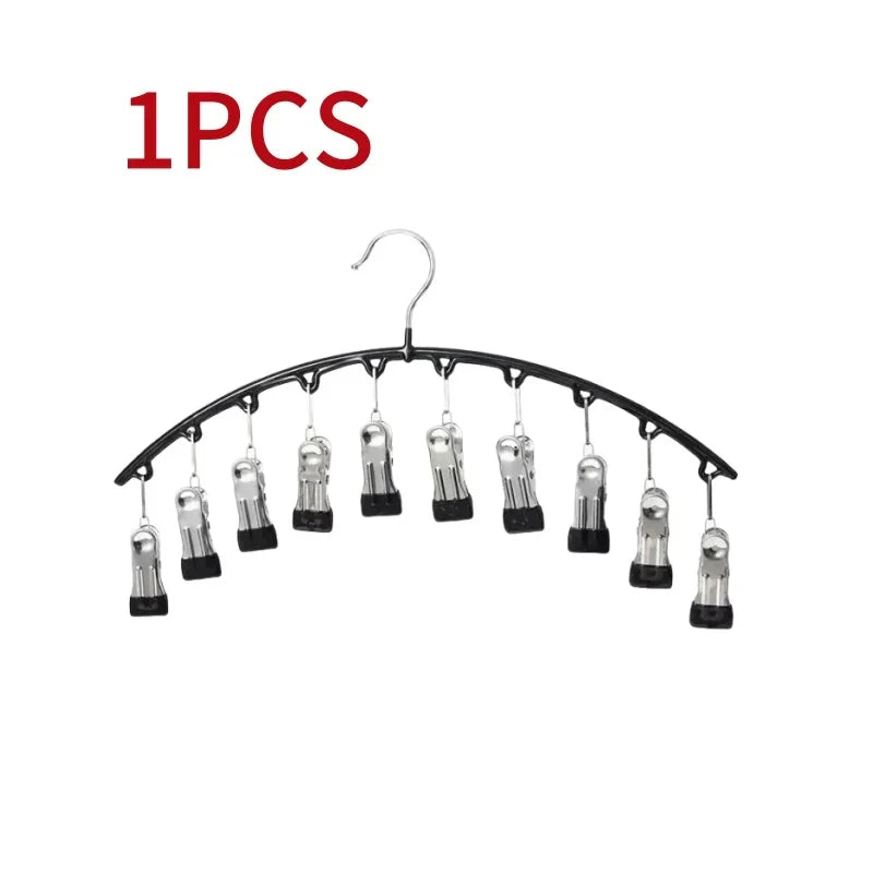 A set of ten metal pant hangers with clips hanging from a wire hanger.