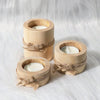 Rustic wooden tea light holder and mini flower pot wrapped with twine on a white fluffy surface