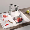 A kitchen faucet is shown spraying water over fresh strawberries in a sink, demonstrating multi-flow settings.