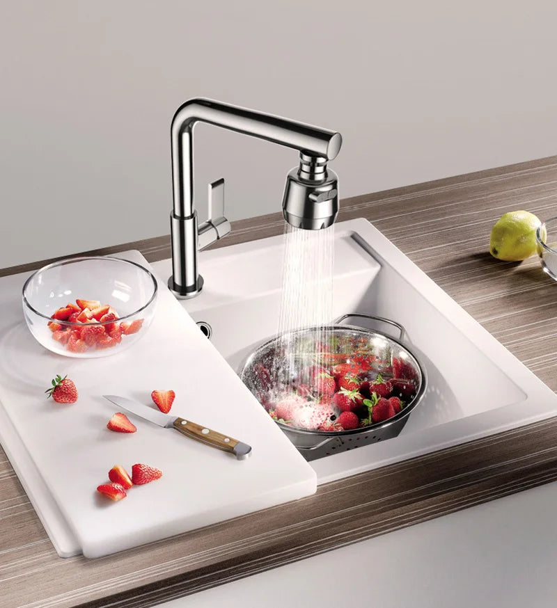 A kitchen faucet is shown spraying water over fresh strawberries in a sink, demonstrating multi-flow settings.