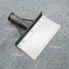 A silver cleaning shovel with a handle and measuring lines is shown against a gray textured background.