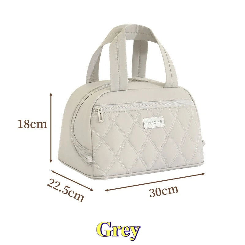 A light grey quilted PU leather insulated lunch tote with a flap and handles.