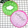 A sliced kiwi fruit design used as a waterproof shower cap for women on a grid background.