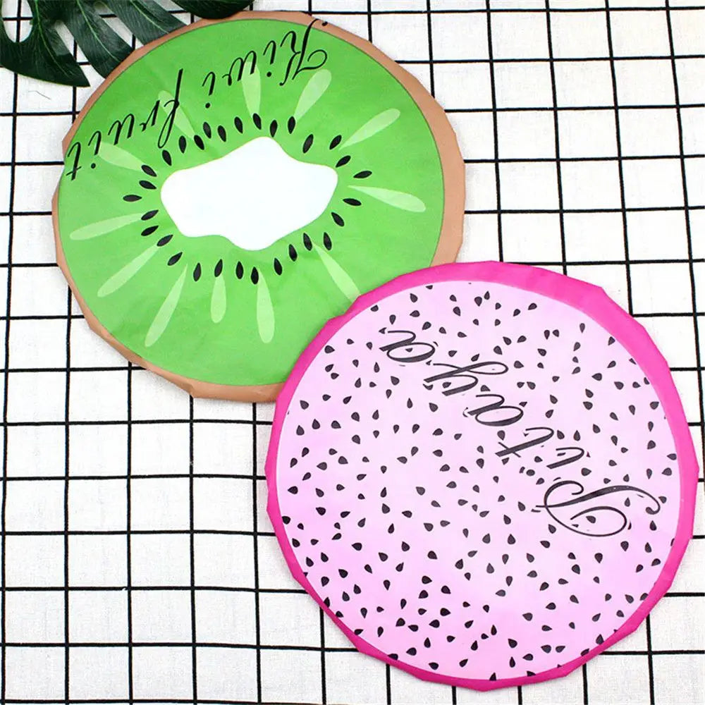 A sliced kiwi fruit design used as a waterproof shower cap for women on a grid background.