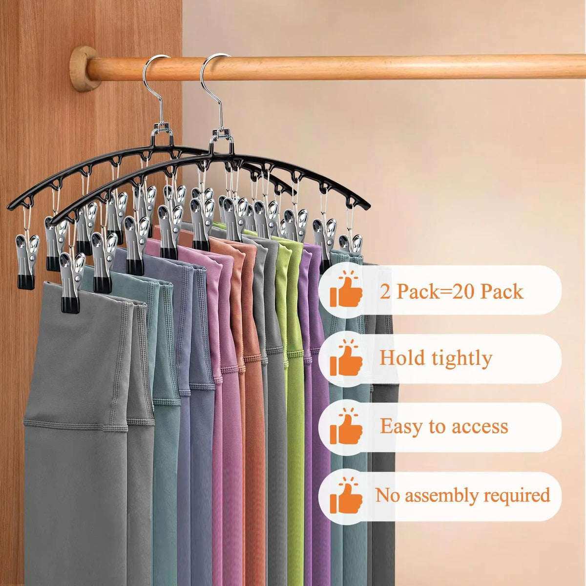 A display of stainless steel hangers with various colored fabric garments hanging on a wooden rod.