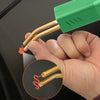 A hand holds a plastic welding repair kit with a staple gun, showing the tool and wire setup.