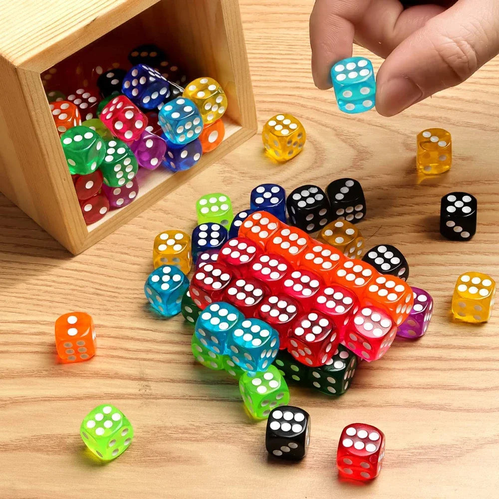 A collection of multicolor acrylic D6 dice in various colors and shapes are displayed on a wooden surface.