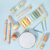 A collection of wooden percussion instruments including mallets, sticks, and a tambourine for kids.