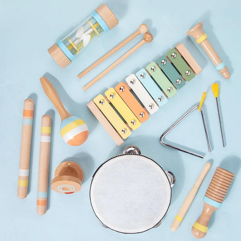 A collection of wooden percussion instruments including mallets, sticks, and a tambourine for kids.