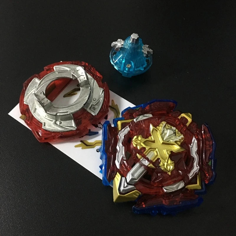 A red metal battle spinning top with a silver ring and a blue crystal top are displayed on a dark surface.