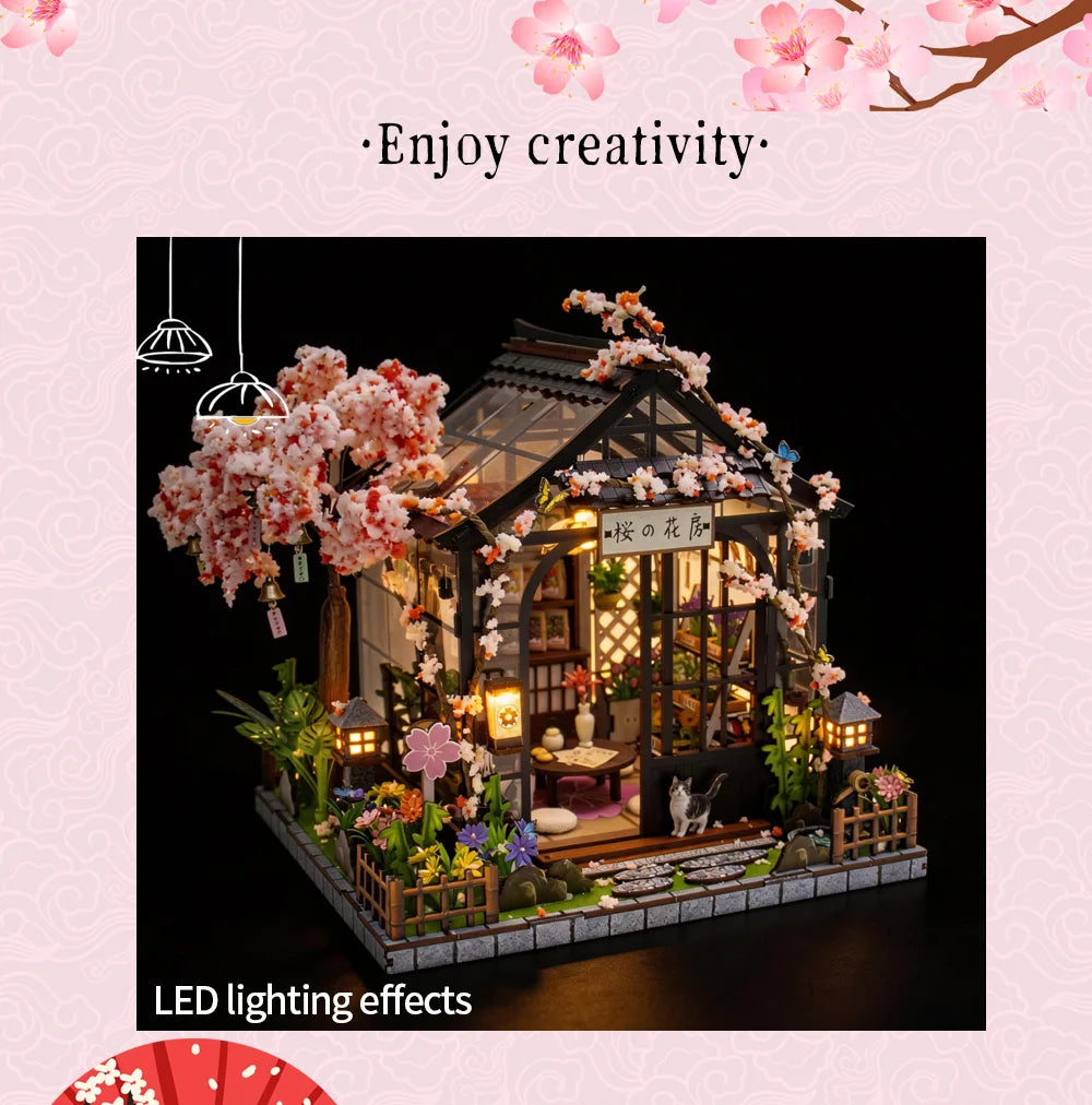 A miniature Japanese sakura tea house model featuring flowering branches and LED lighting effects.