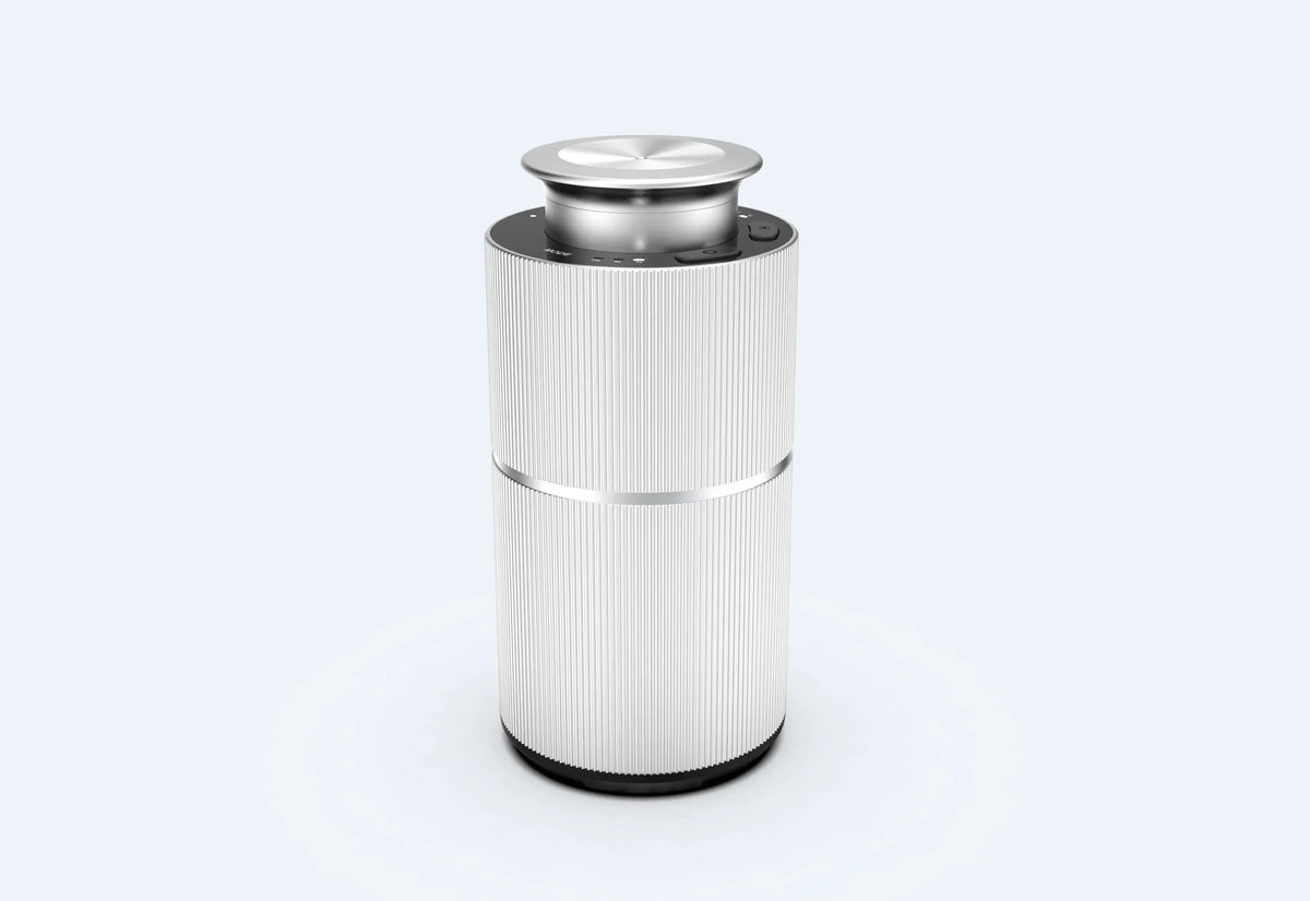 A silver portable waterless essential oil diffuser with a round top and cylindrical body.