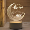 A glowing crescent moon acrylic night light featuring Arabic calligraphy and mosque silhouettes.