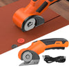 Orange cordless rotary scissors with a safety lock shown on a brown mat and detached.