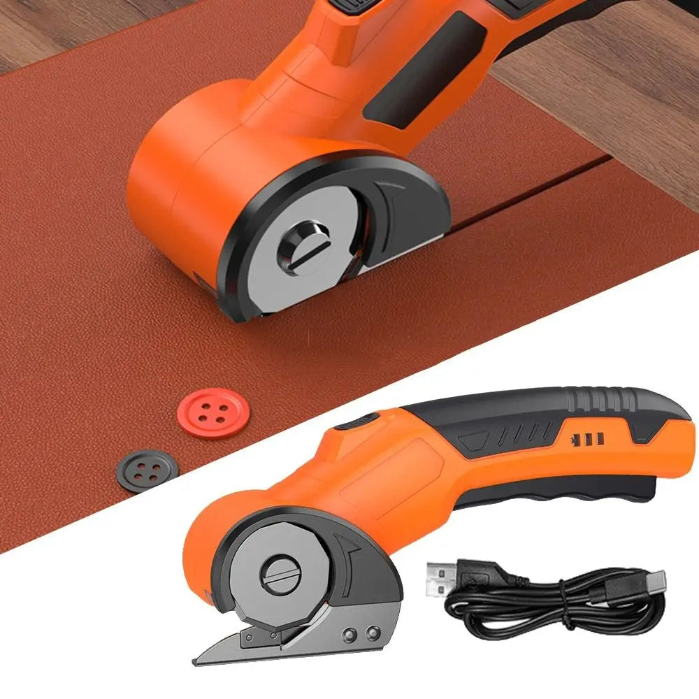 Orange cordless rotary scissors with a safety lock shown on a brown mat and detached.