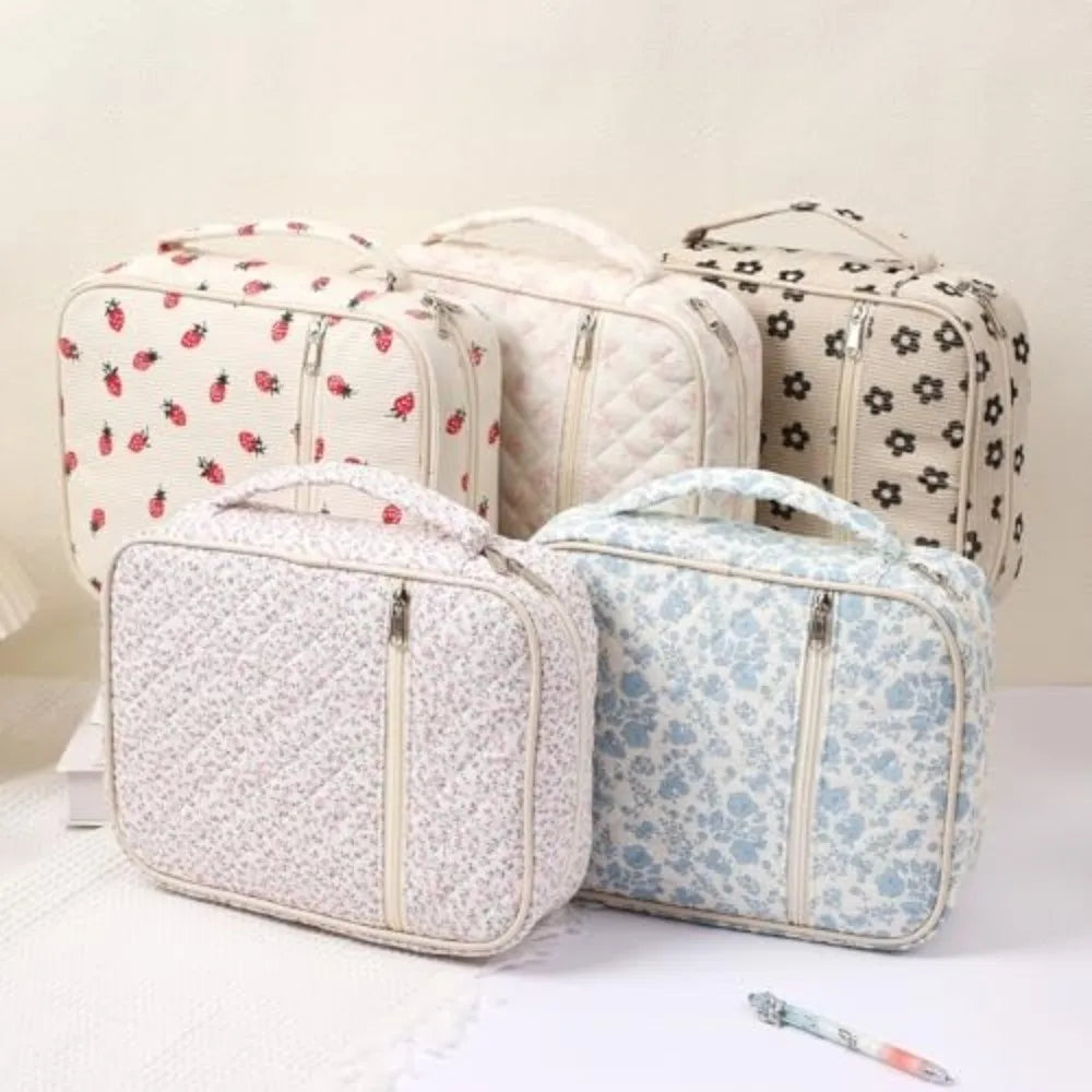 A set of four floral quilted Bible covers in cream and beige fabric with zipper pockets and carry handles.
