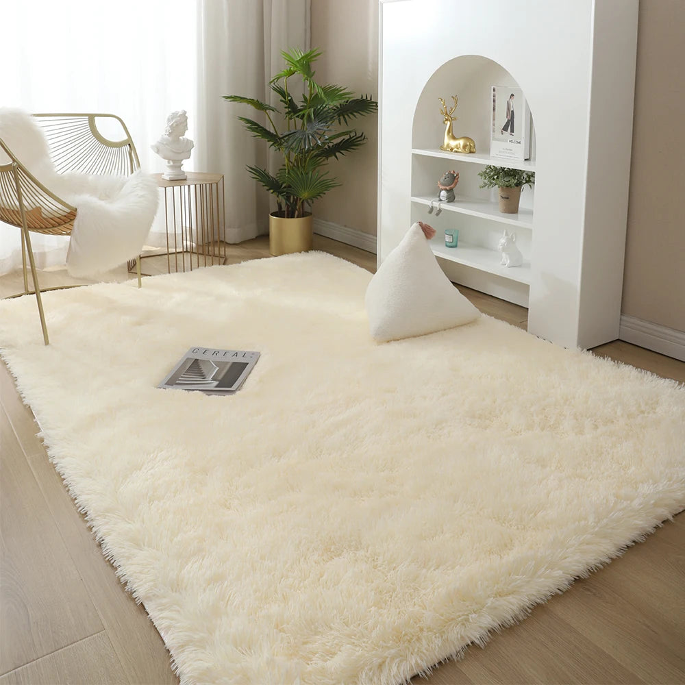 A fluffy cream colored rug in a modern living space with white furniture and indoor plants.