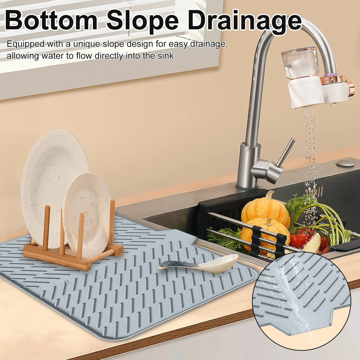 Silicone dish drying mat with a drainage ramp placed next to a kitchen faucet