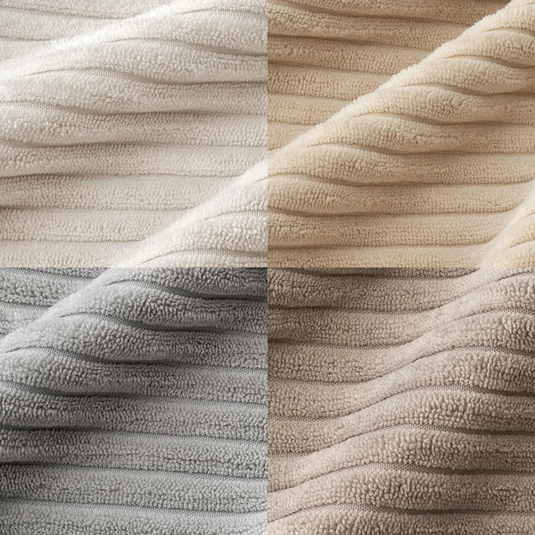 Close-up of a soft corduroy striped fabric in beige and gray tones, showing a textured weave.
