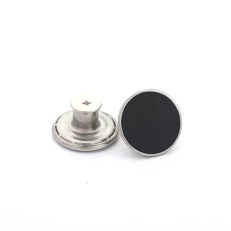 A silver metal button and a round black button are shown for a jeans button repair kit.