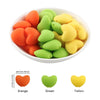 A bowl filled with ten silicone heart beads in orange, green, and yellow colors.
