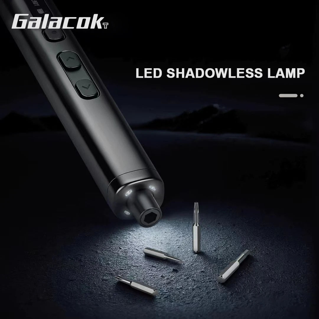 A close-up view of a metallic LED shadowless lamp and several precision screwdriver bits on a dark surface.