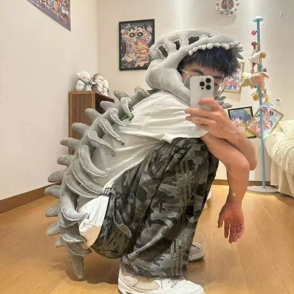 Person in dinosaur bone head costume accessory with gray and white textured fabric.