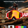 A pair of red and pink motocross goggles with a yellow lens are shown in an action shot on a dirt bike.